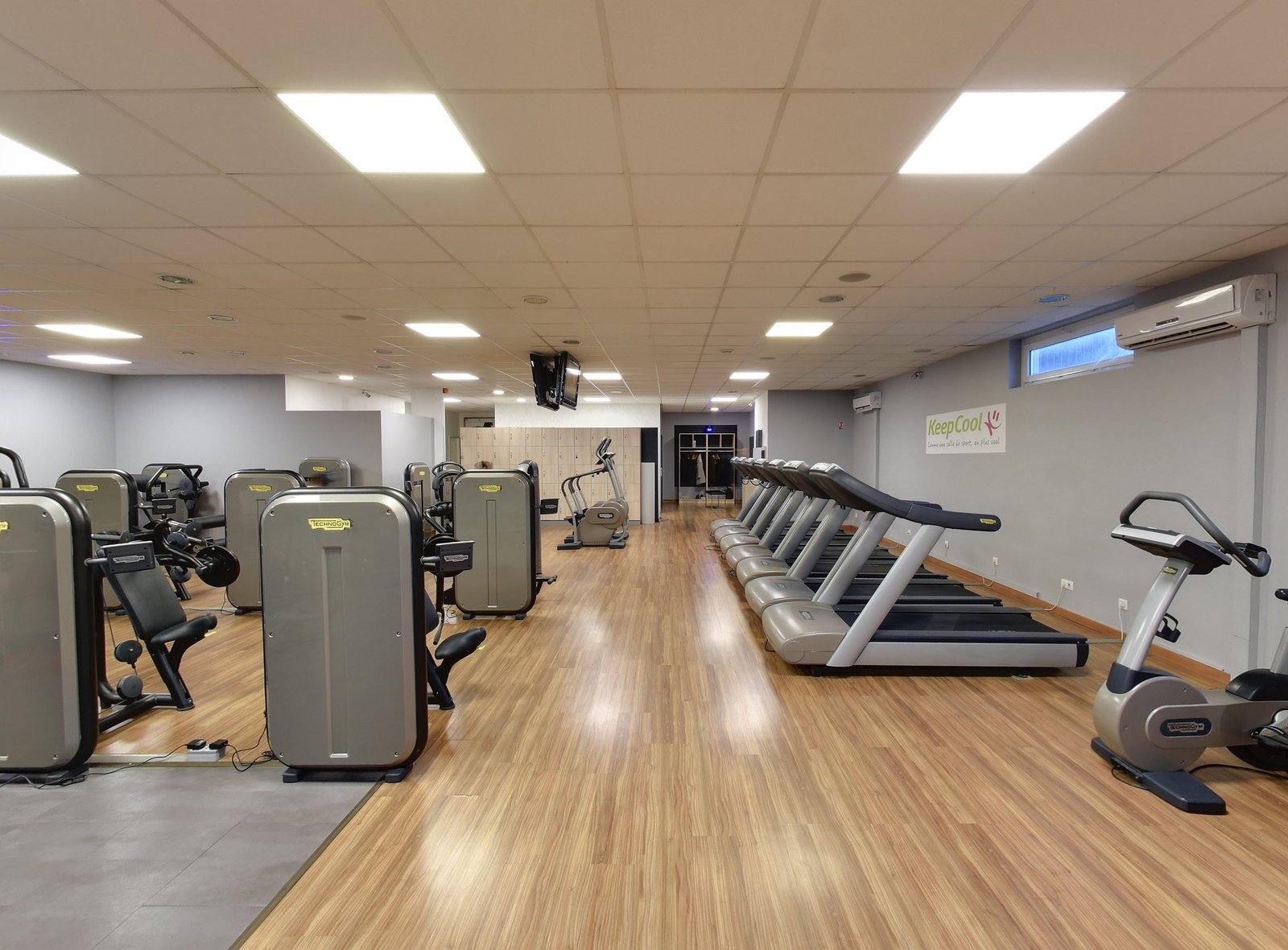 Modern gym equipment including treadmills and weights